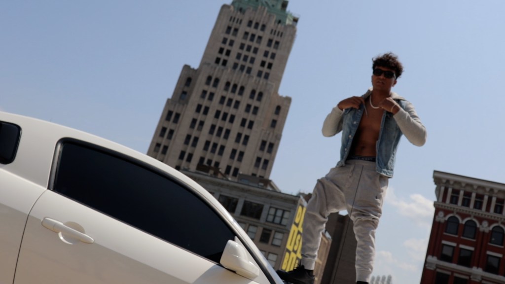 tazmin ohio rapper image standing on top of his mustang